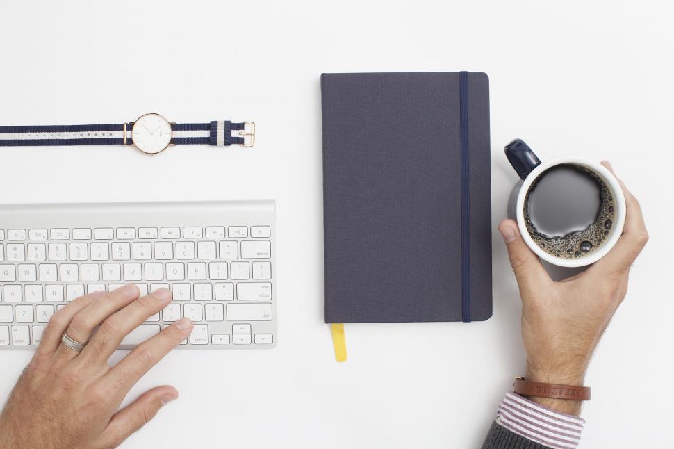 Free Image of Person Typing on Keyboard and Using Mouse With Coffee Cup on Desk 
