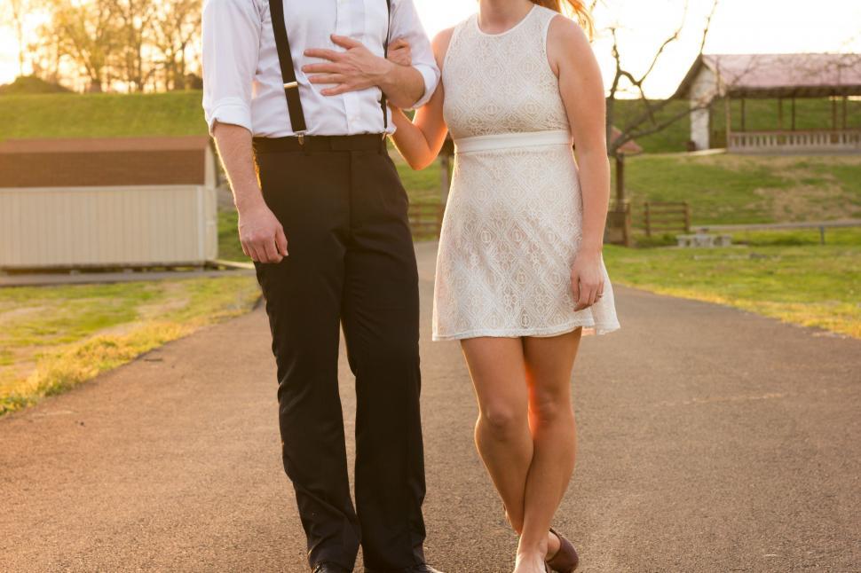 Free Image of Man and Woman Walking Down a Road 