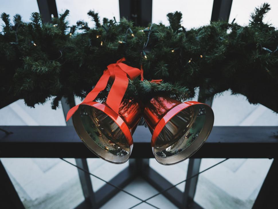 Free Image of Red Bells Hanging From Christmas Tree 