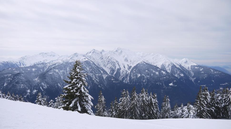 Free Image of Man Snowboarding Down Snow-Covered Slope 