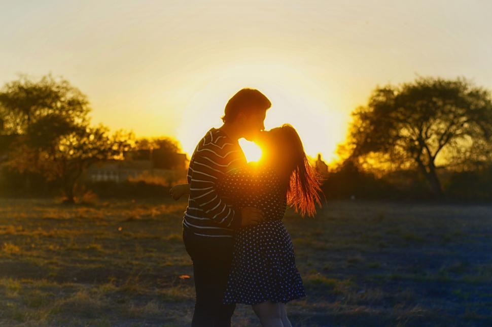 Free Image of Woman Standing in Field at Sunset 