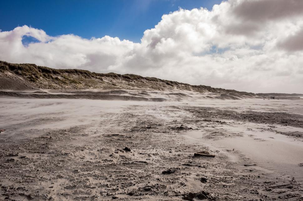 Free Image of Cloudy Blue Sky Over Sandy Beach 