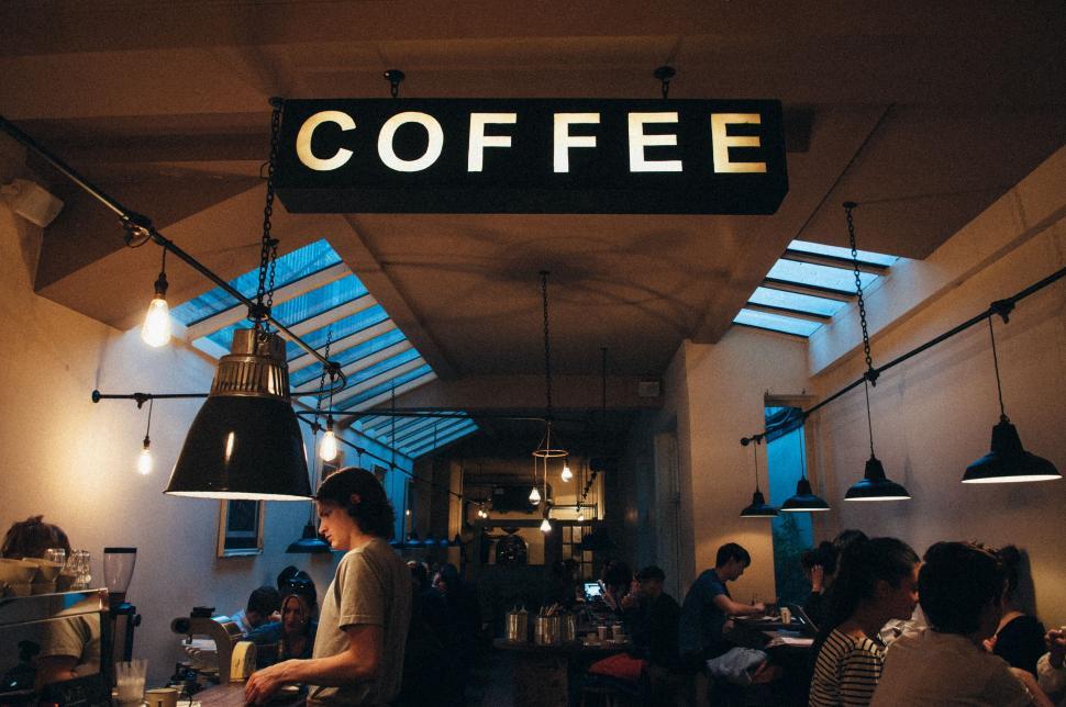 Free Image of Group of People Sitting at a Coffee Shop Table 