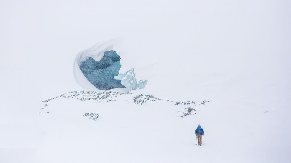 Free Image of Man Standing on Top of Snow Covered Slope 