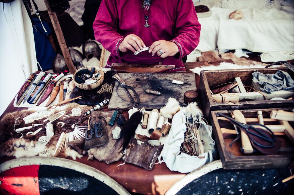 Free Image of Man Standing in Front of Table Filled With Items 