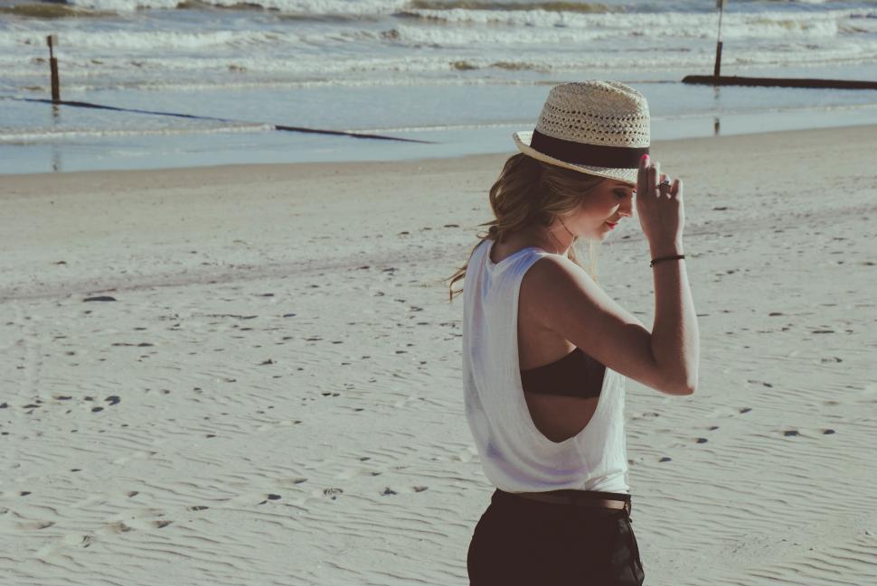 Free Image of Woman Standing on Sandy Beach 