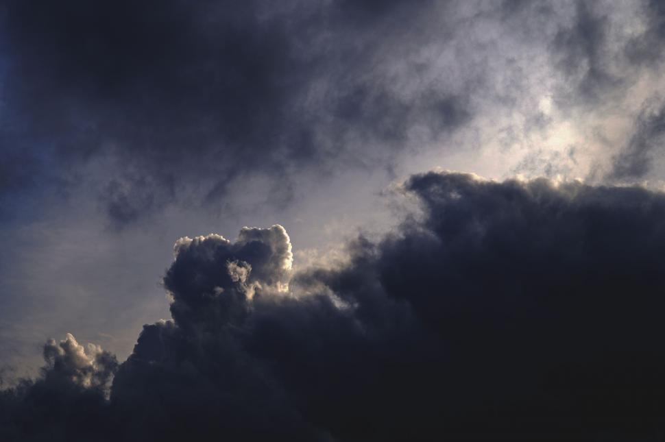 Free Image of Plane Flying Through Dark Cloudy Sky 