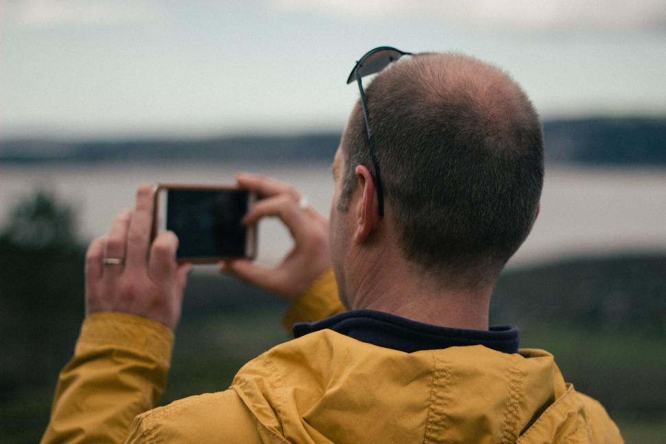 Free Image of Man Taking Picture With Cell Phone 