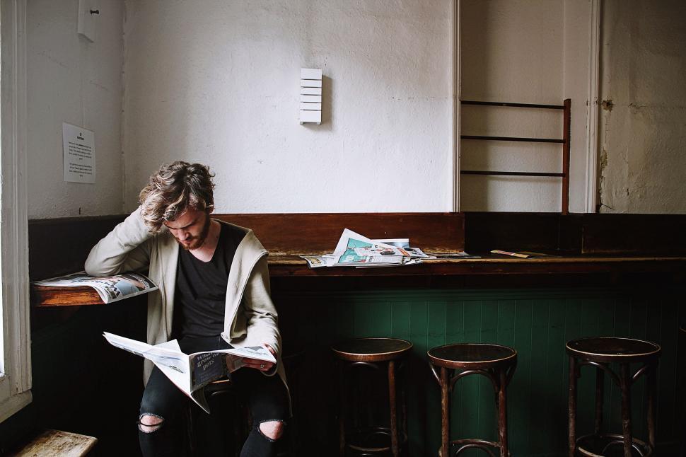 Free Image of Man Sitting on Bench Reading Book 