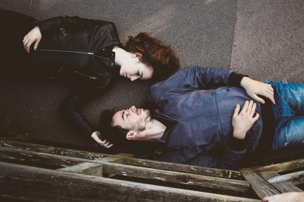Free Image of Couple Laying on Ground 