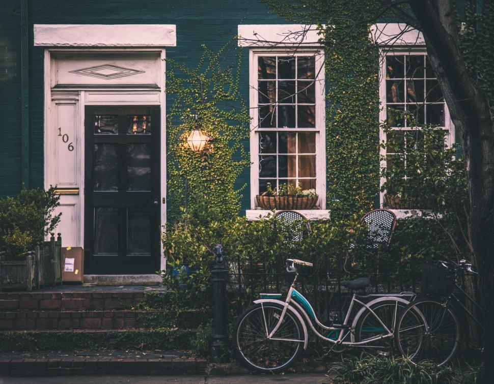 Free Image of Bicycle Parked in Front of Green Building 