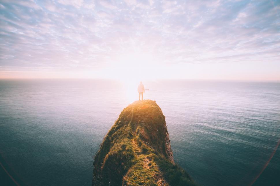 Free Image of Person Standing on Cliff Overlooking Ocean 