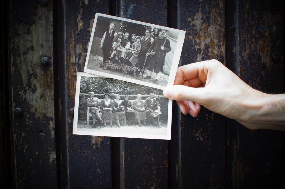 Free Image of Hand Holding Group Photo 