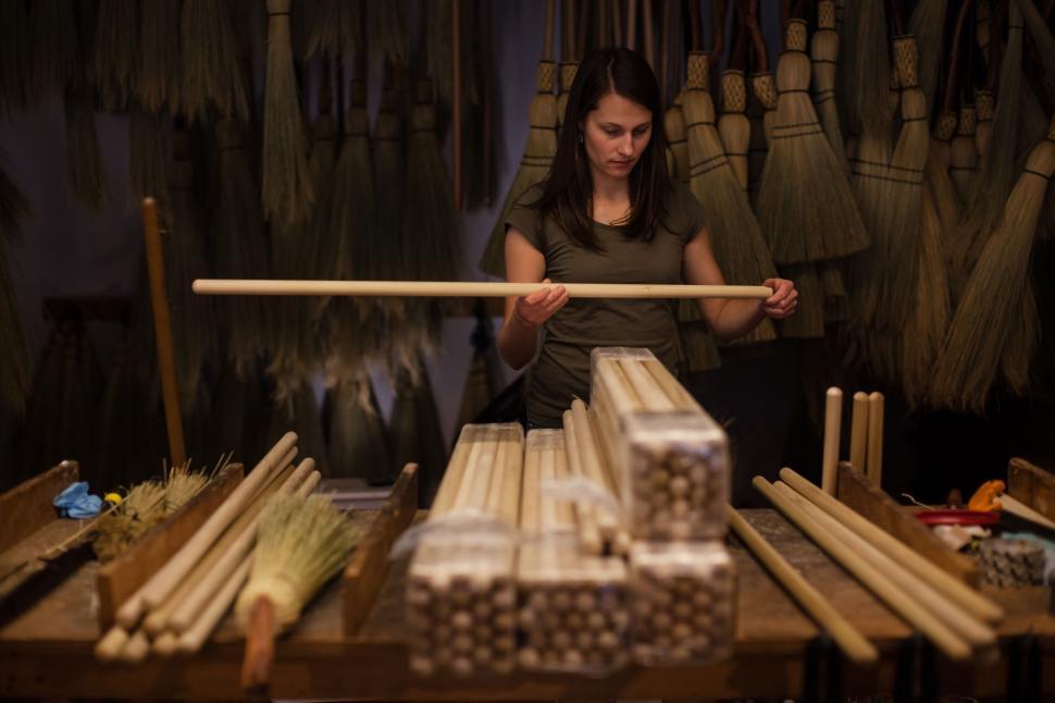 Free Image of Woman Holding a Stick in a Shop 