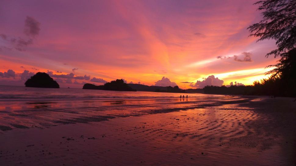 Free Image of People Walking on Beach at Sunset 