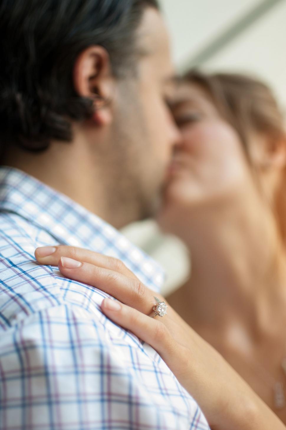 Free Image of Man and Woman Kissing in Front of Mirror 