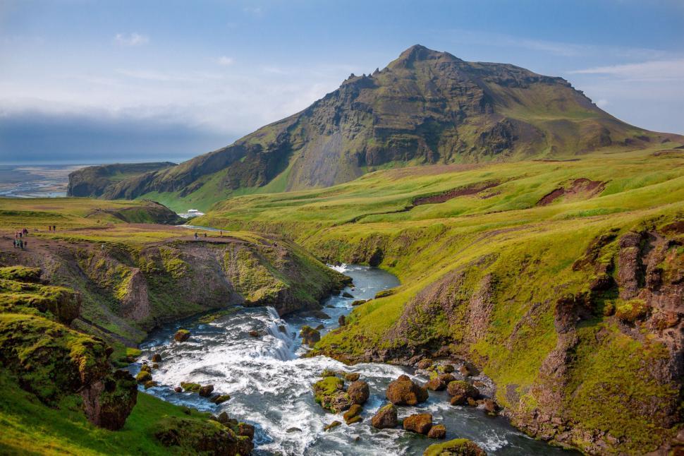 Free Image of River Flowing Through Lush Green Valley 
