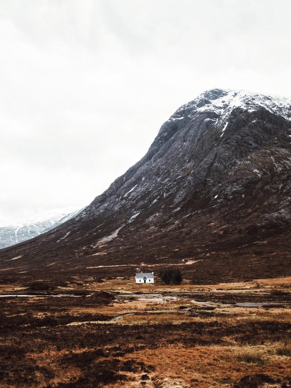 Free Image of House in Field With Mountain Background 