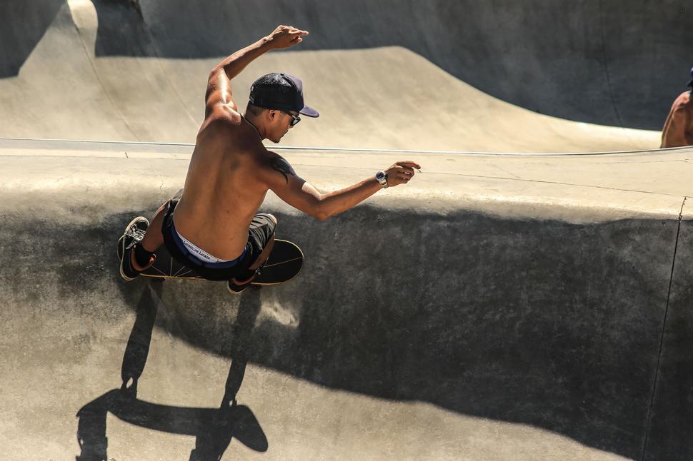Free Image of Man Riding Skateboard Up Ramp 