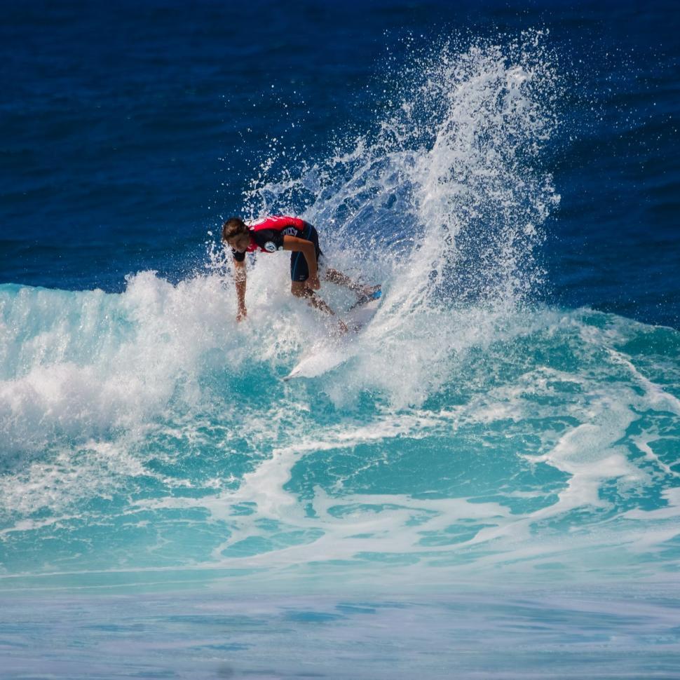 Free Image of Man Riding Wave on Surfboard 