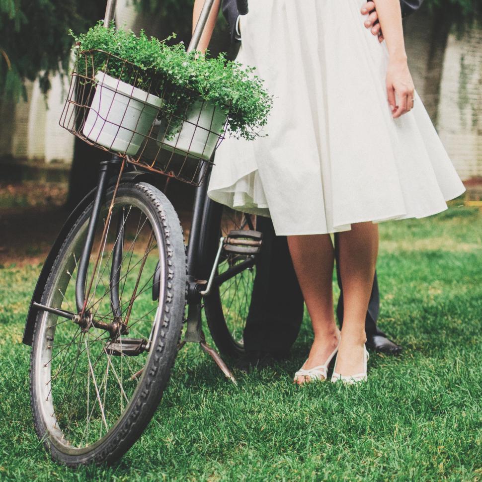 Free Image of Man and Woman Standing Next to Bike 