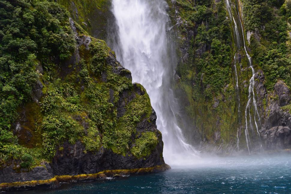 Free Image of Boat Sailing Near Waterfall 
