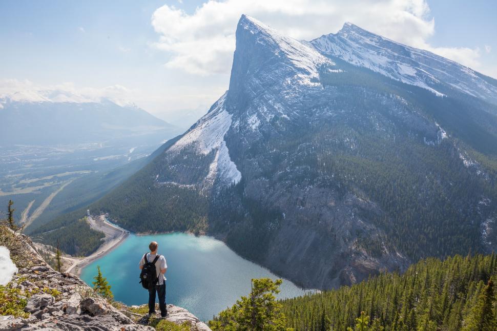 Free Image of Person Standing on Top of Mountain Overlooking Lake 