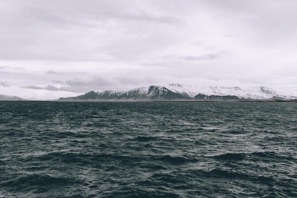 Free Image of Majestic Mountain Towers Over Vast Lake 