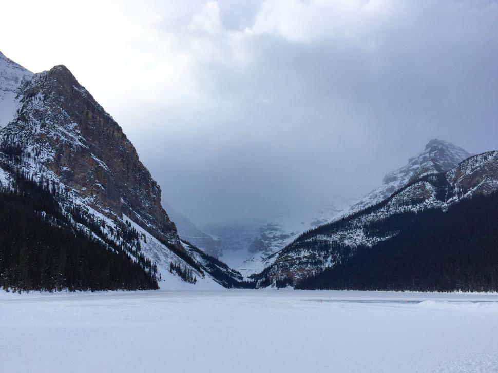 Free Image of Person Skiing in Snow With Mountains Background 