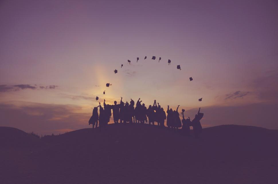Free Image of Group of People Standing on Top of a Hill 