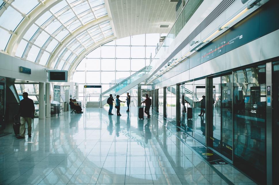 Free Image of Group of People Walking Through an Airport Terminal 