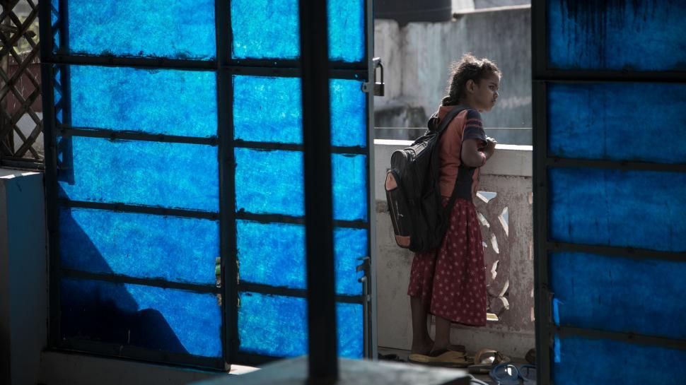 Free Image of Woman in Red Dress Standing in Doorway 