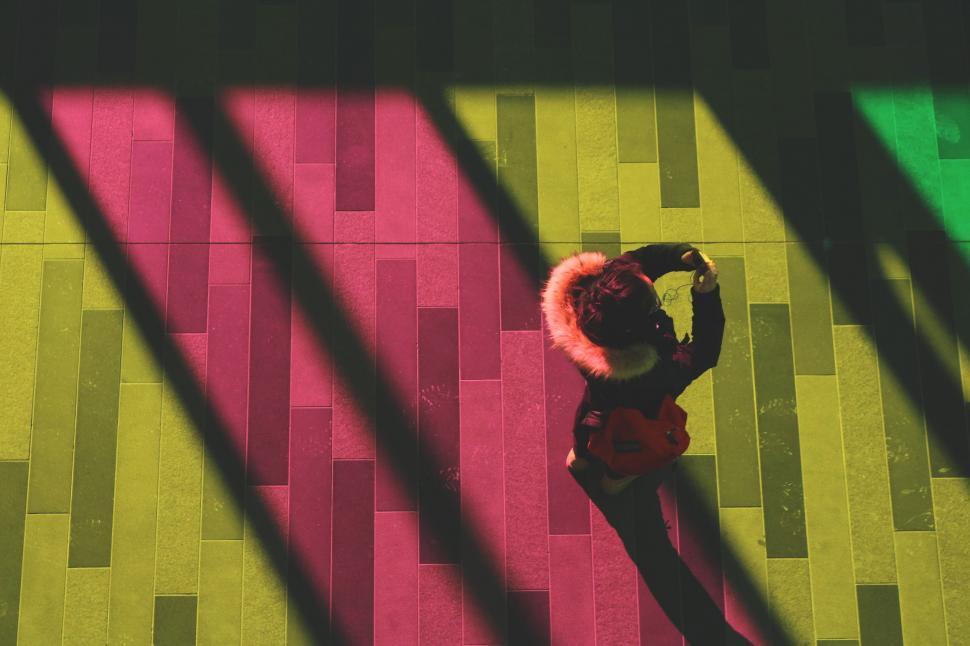 Free Image of Woman Standing on Tiled Floor Next to Window 