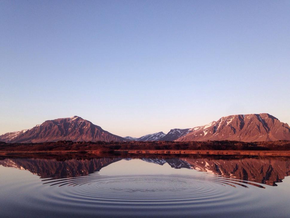 Free Image of Majestic Mountains Towering Over a Pristine Water Body 