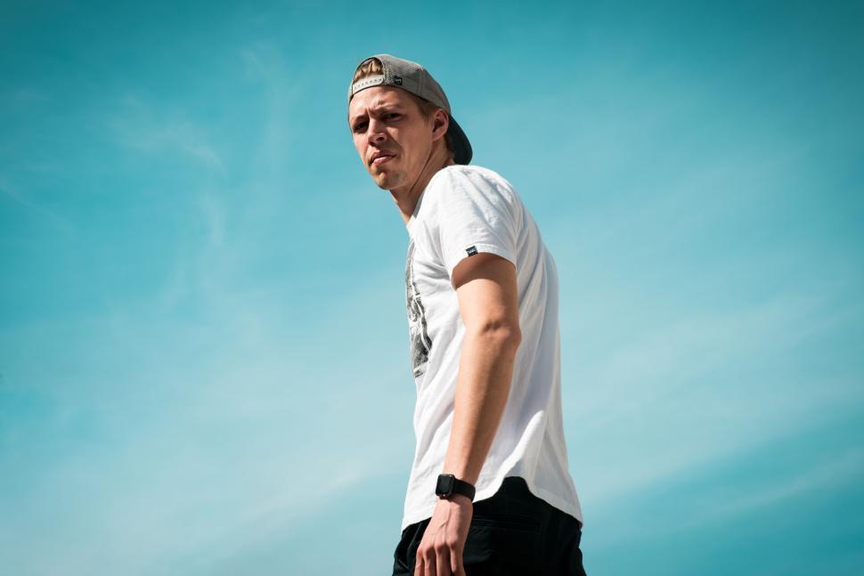 Free Image of Man Skateboarding in White Shirt and Black Shorts 