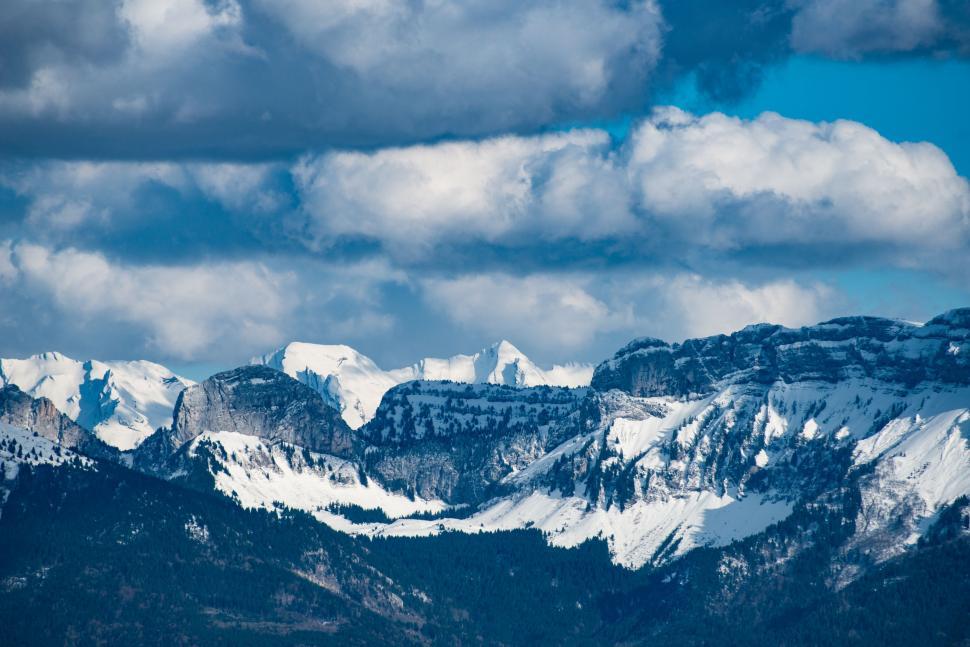 Free Image of Snow Covered Mountain Range Under Cloudy Sky 