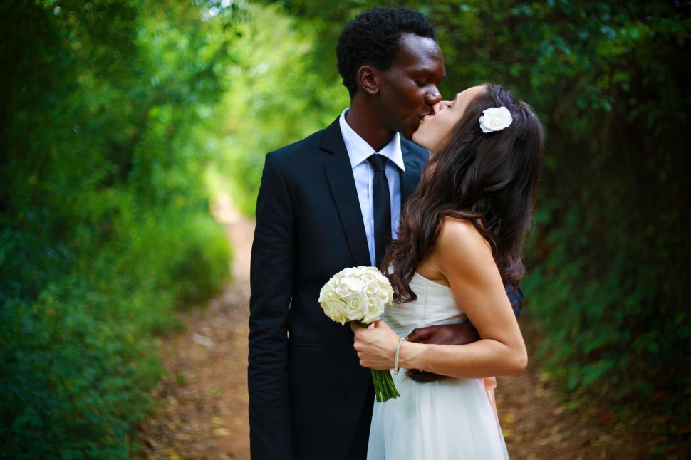 Free Image of Bride and Groom Kissing on Dirt Path 