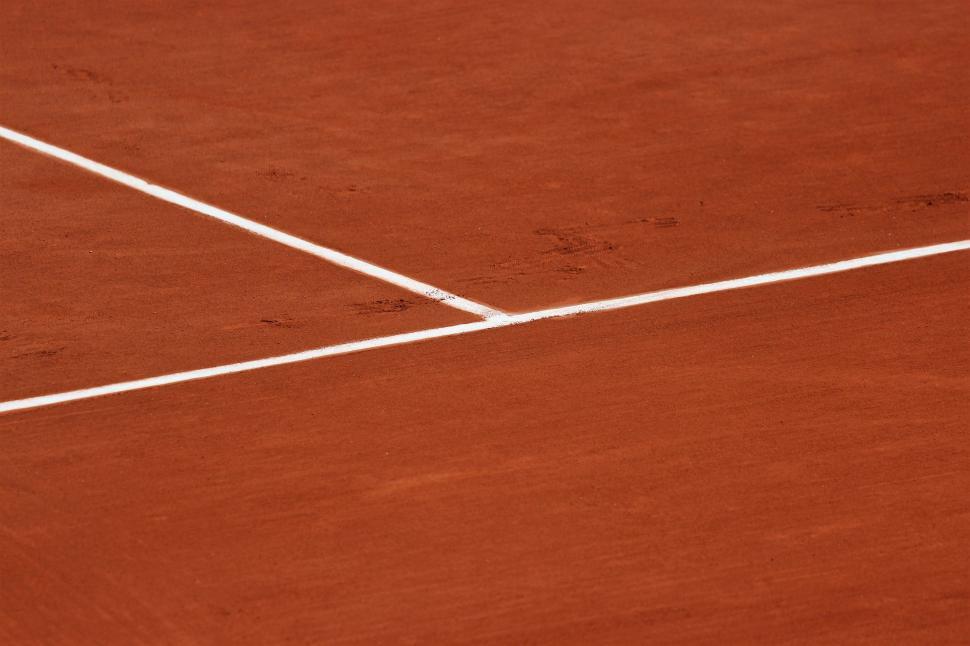 Free Image of Man Standing on Tennis Court Holding Racquet 