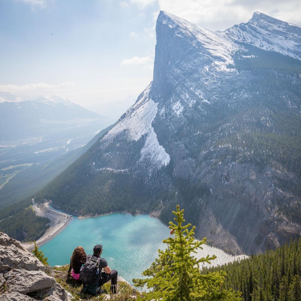 Free Image of Couple Sitting on Top of a Mountain 
