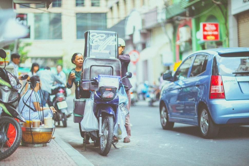Free Image of Group of People Riding Scooters Down a Street 