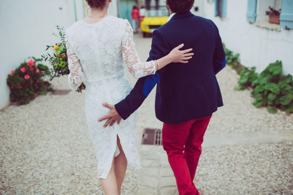 Free Image of Man and Woman Walking Down a Street 