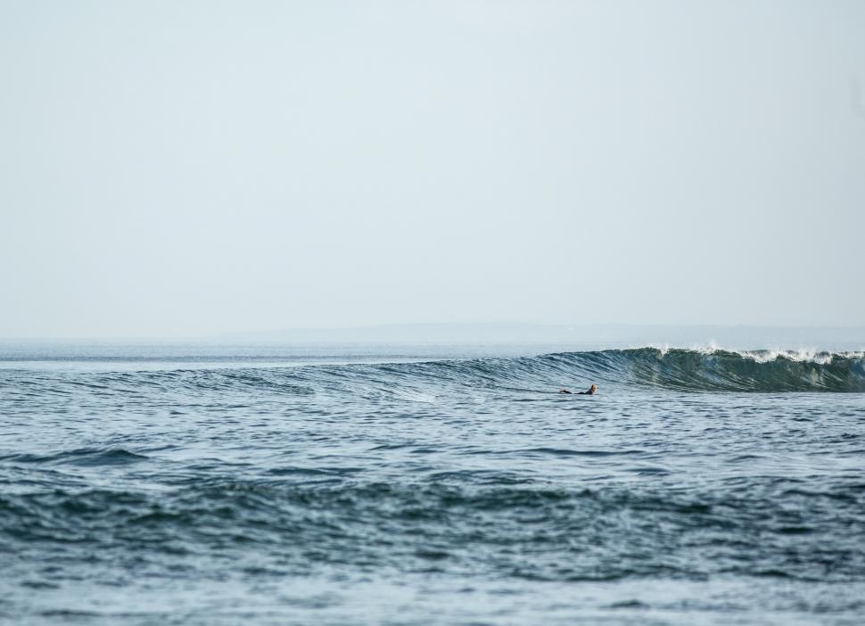 Free Image of Man Riding Wave on Surfboard 