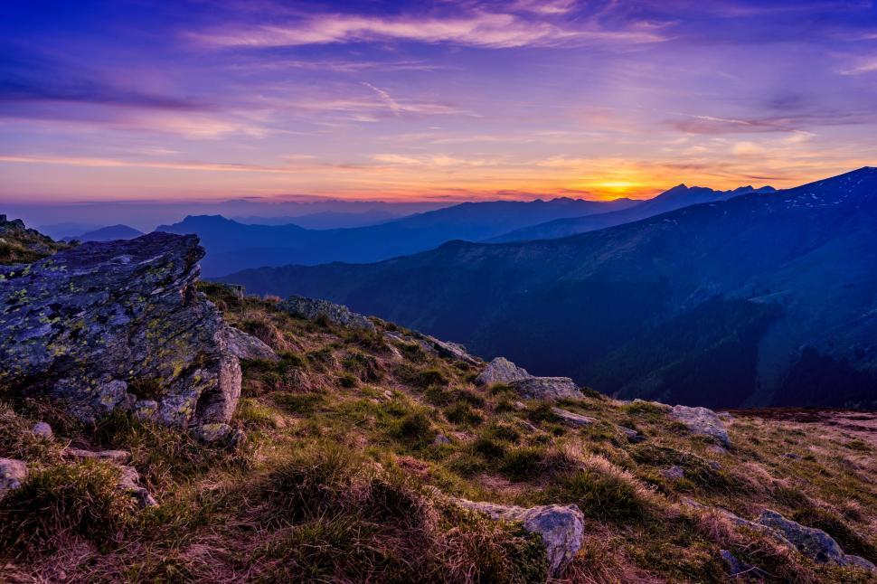 Free Image of Sun Setting Over Distant Mountains 