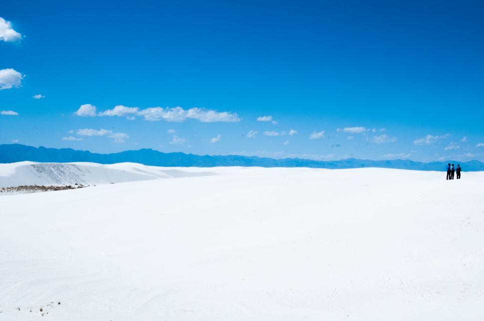 Free Image of People Standing on Snow Covered Slope 