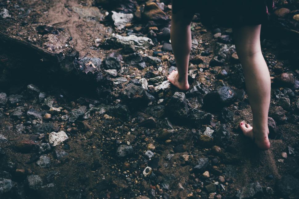 Free Image of Person Walking on Rocky Path With Teddy Bear 