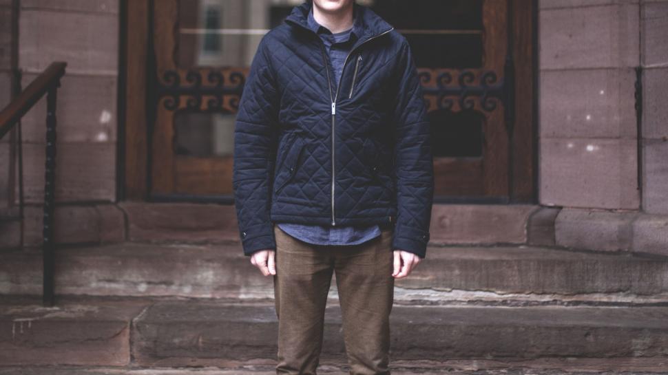 Free Image of Man Standing in Front of Building 