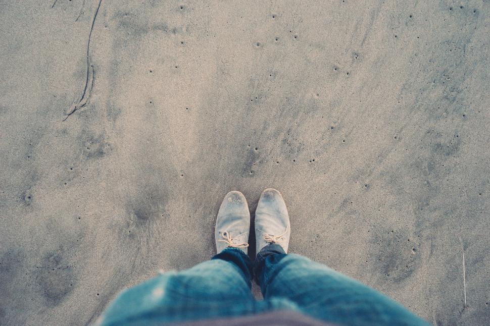 Free Image of Person Standing on Top of Sandy Beach 