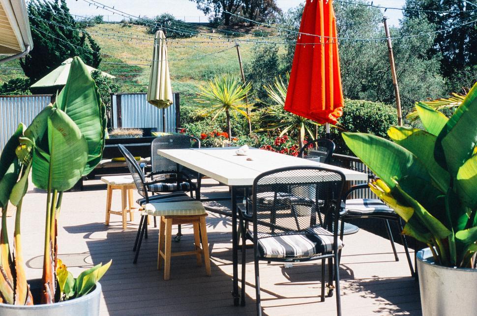 Free Image of Patio With Table, Chairs, and Umbrellas 