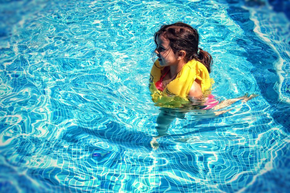 Free Stock Photo of Little Girl Learning To Swim with Life Vest