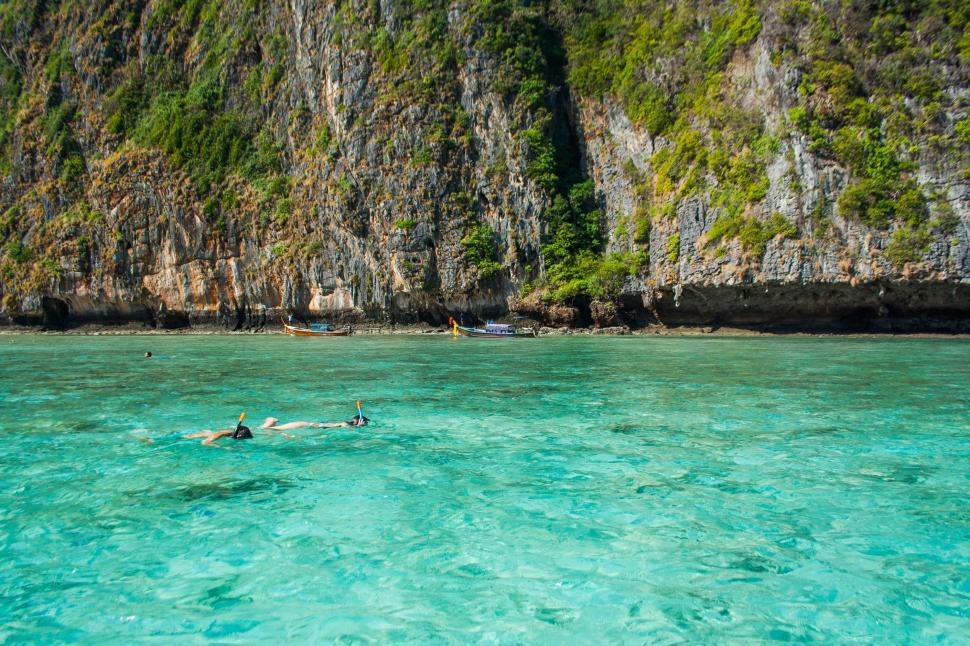 Free Image of Person Swimming in Ocean Near Mountain 
